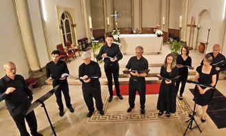 Members of the Art of Music in black concert dress in a church